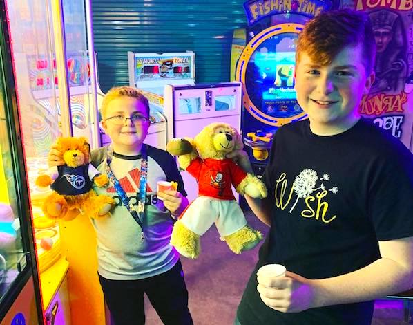 two boys with arcade prizes